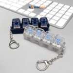 Hand pressing keycap on keyboard fidget toy showing bright blue led flash