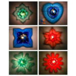 Multicolor transparent reflection diyas burning around a colorful diwali floor rangoli