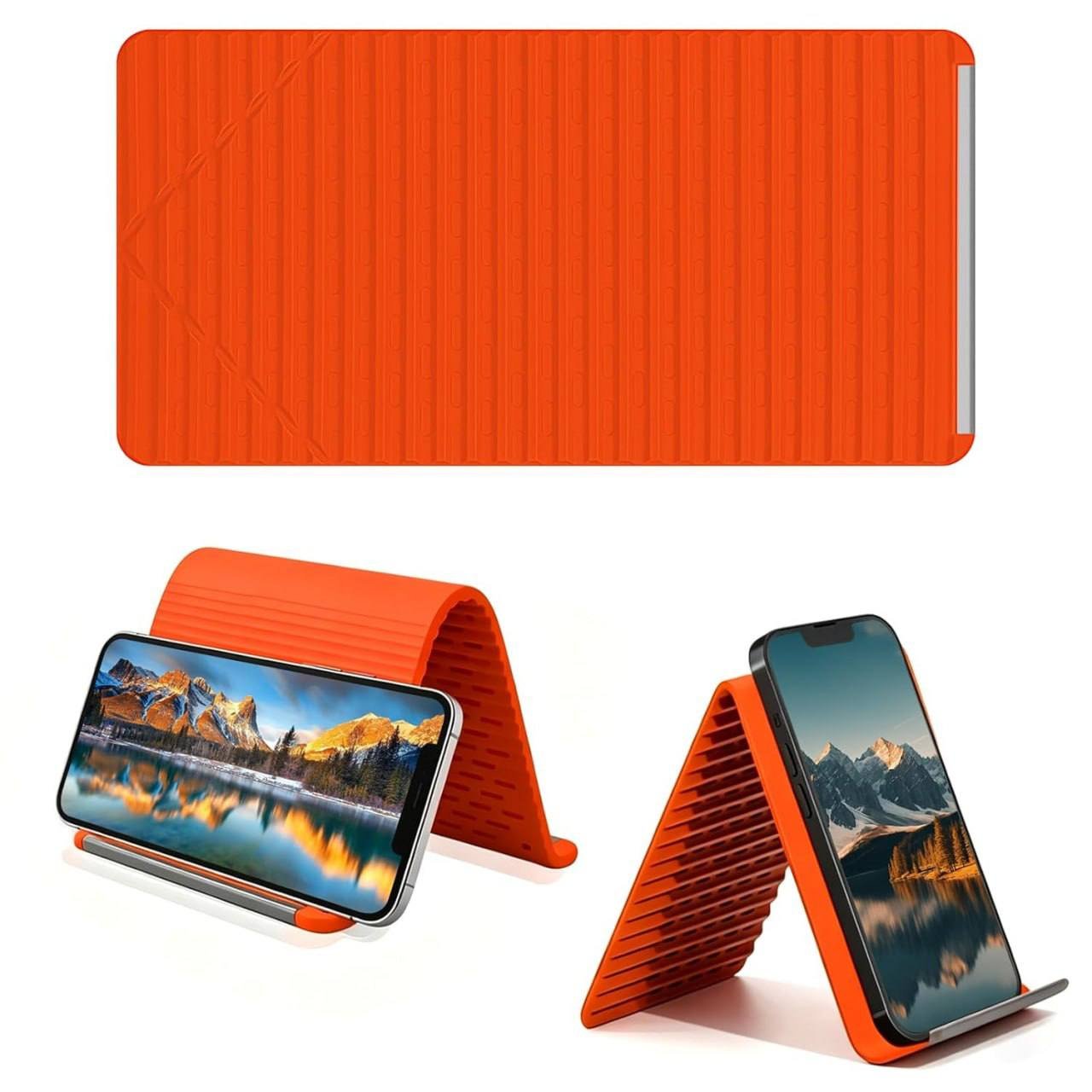 Foldable silicone phone stand orange bent into desktop mobile holder on clean surface